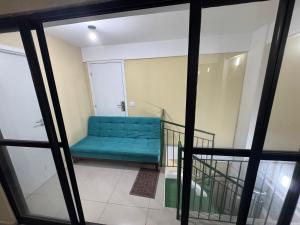 een blauwe bank in een kamer met ramen bij Rooftop Carneirinho in Tamandaré +10 foto's