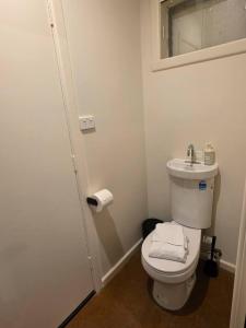 a bathroom with a white toilet and a sink at A Sweet Studio for One in Altona