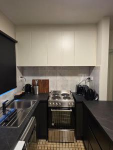 a kitchen with a stove and a sink at A Beachside Villa with Vogue Verve in Altona +14 photos