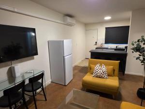 a living room with a couch and a refrigerator at A Beachside Villa with Vogue Verve in Altona