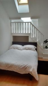 a bedroom with a bed and a stair case at Eastgate Apartment in Inverness