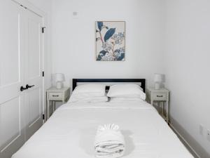 a bedroom with a white bed with two night stands at The View - Navy Yard Washington DC in Washington, D.C. +78 photos