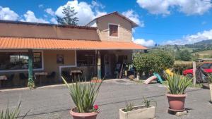 een gebouw met potplanten ervoor bij Cabaña con chimenea Paipa in Paipa