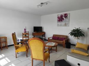 a living room with a couch and a table at Gîte menthe à l'eau in Ciadoux