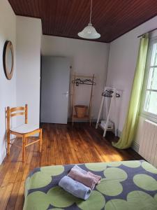 a bedroom with a bed and a wooden floor at Gîte menthe à l'eau in Ciadoux