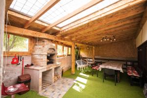 a large room with a brick oven and a table at Casa Dracea in Comarnic