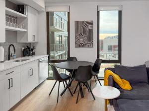 a kitchen and living room with a table and a couch at The View - Navy Yard Washington DC in Washington, D.C.