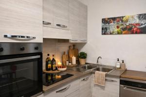 a kitchen with a sink and a stove at La casa di Marzapane in Spigno Saturnia
