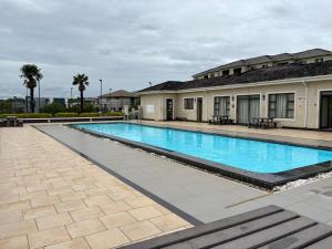 a large swimming pool in front of a building at The Gentle Nest in Trevallyn