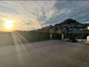 un parking avec le soleil couchant en arrière-plan dans l'établissement spa de nage et jacuzzi à Séverac d'Aveyron, à Sévérac d' Aveyron