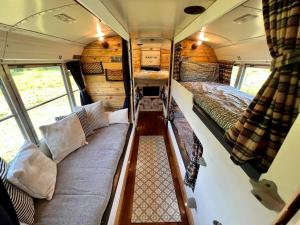 an interior view of an rv with two beds at Camp Bonnie in Kent