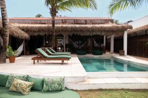 a resort with a swimming pool and palm trees at Kitenest in Itarema