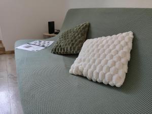 two pillows sitting on top of a bed at L'instant Doubs in Baume-les-Dames