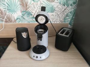a coffee maker and a clock on a table at L'instant Doubs in Baume-les-Dames