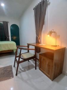 a room with a desk and a chair and a bed at Omah Barepan Temple View in Borobudur