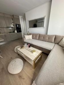 a living room with a couch and a coffee table at Apartman Centar - Posušje in Posušje