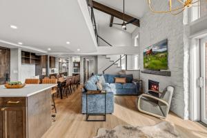 a living room with a blue couch and a fireplace at Bear Claw 402 - Premier Ski-in Ski-out & Winter Shuttle! Renovated 2025! in Steamboat Springs