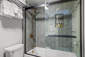 a shower with a glass door in a bathroom at Bear Claw 402 - Premier Ski-in Ski-out & Winter Shuttle! Renovated 2025! in Steamboat Springs +22 photos