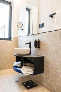 a bathroom with a sink and a mirror at Mercure Bucharest Cantemir in Bucharest