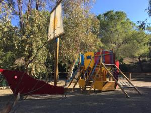a group of playground equipment in a park at Camping Village Stella Mare in Lacona