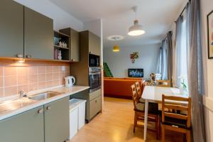 a kitchen and dining room with a table and a couch at Boží Dar 95 in Boží Dar +10 photos