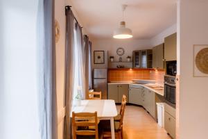 a kitchen with a table and a dining room at Boží Dar 95 in Boží Dar