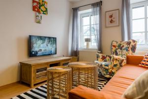 a living room with a couch and chairs and a tv at Boží Dar 95 in Boží Dar