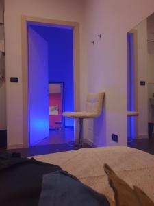 a blue room with a chair and a bed at Mini Hostel 404 in Turin