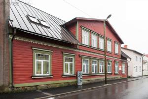 a red building on the side of a street at Roosi Apartment in Pärnu