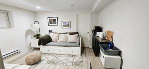 een witte woonkamer met een bank en een tafel bij Small Private Studio at Kitsilano Beach in Vancouver