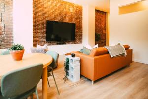 a living room with a couch and a table at Historic Charming 2BR Apartment DT Halifax in Halifax