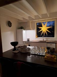 a kitchen with a table with a star on the wall at Gustavsbo in Ljungbyhed