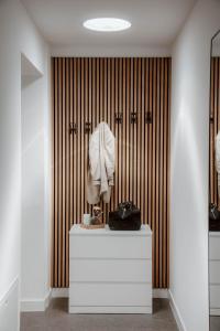 a room with a white dresser in front of a wall at Das Naturlich - Ruhiges Apartment Hotel nahe Regensburg in Sinzing +135 photos