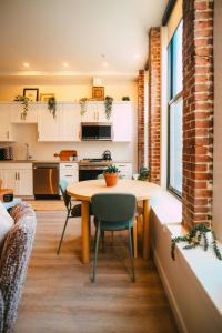 a kitchen and dining room with a table and chairs at Historic Charming 2BR Apartment DT Halifax in Halifax +21 photos