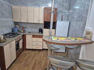 a kitchen with a counter and a table in it at Cozy Žemaitės gatvė in Telšiai