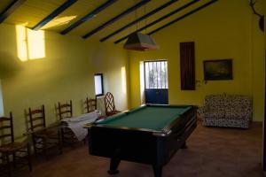 a living room with a pool table and chairs at La Casita del Pastor in Loja