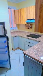 a kitchen with blue cabinets and a counter top at le riffe in Nador