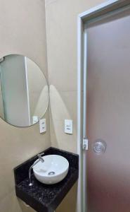a bathroom with a sink and a mirror at Hotel Triangulo Itai in Itaí +19 photos