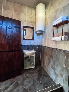 ein Badezimmer mit Waschbecken und Spiegel in der Unterkunft RhodoNest in Kara Agach