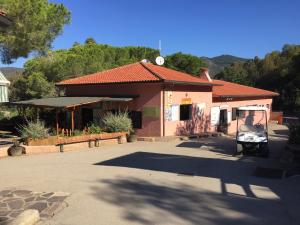 a small house with a golf cart in front of it at Camping Village Stella Mare in Lacona