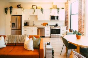 a living room with an orange couch in a kitchen at Historic Charming 2BR Apartment DT Halifax in Halifax