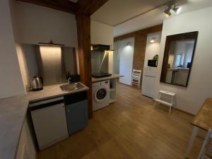 a kitchen with a sink and a stove top oven at Stay with a View in Gdynia