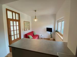 a living room with a red couch and a red table at Stay with a View in Gdynia +19 photos