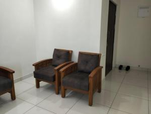 two chairs sitting next to each other in a room at Elegant Stay at Bangalore International Airport in Bangalore +1 photo