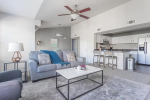 a living room with a couch and a table at Landing Spectacular 1BD Pool Courtyard in Broken Arrow