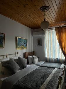 a bedroom with a bed and a couch in it at Andria's Apartment in Gjirokastër