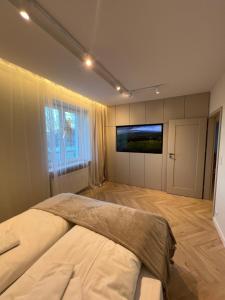 En eller flere senge i et værelse på Nowy Apartament Kowary