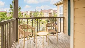 een balkon met twee stoelen en een tafel bij Landing Amazing 2BD in Broken Arrow in Broken Arrow