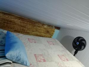 a bedroom with a bed and a fan at Hostel & Cia Itanhaém in Itanhaém +173 photos