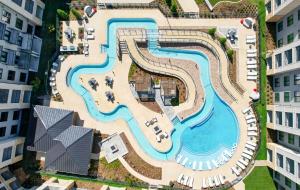 an aerial view of a swimming pool in a building at Landing Apartments - The Quinn in Anna